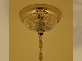 Ceiling rose of the chandelier with a crystal cover